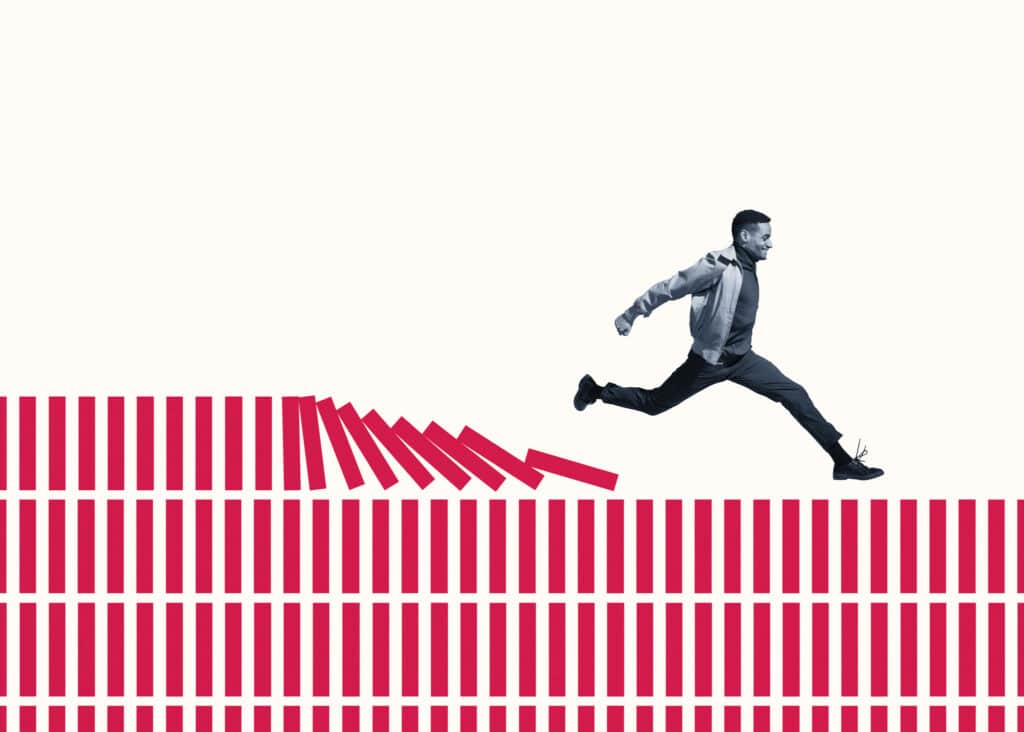 Happy young man running on red columns