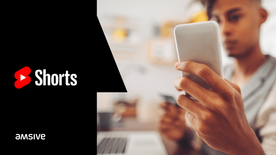 a man is using a cell phone with the words shorts on it.